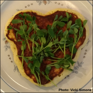 Heart-shaped pancake covered with Speckled Pea microgreens.