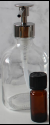 Glass oil dispenser with essential oil bottle